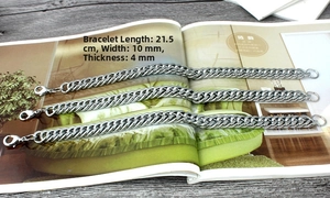 Flat lay of 10mm wide silver Cuban link chain with 21.5cm length and lobster clasp