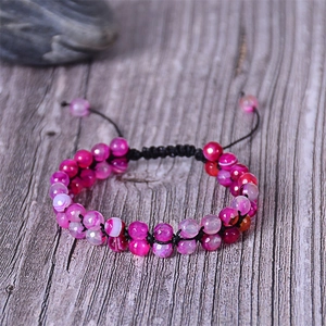 Macro view of double-layer purple agate beads on an adjustable woven bracelet cord