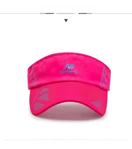 Detail view of pink sports sun visor with blue sports logo and decorative brim pattern