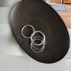 Close-up of interlocking 925 sterling silver rings with high-polish minimalist finish