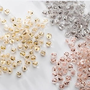 Macro shot of silver, gold, and rose gold silicone butterfly earring backings