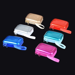 Detailed view of six colorful mini suitcase-shaped hard shell storage cases with zippers
