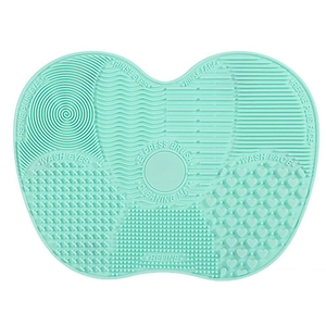 Mint green silicone makeup brush cleaning mat with suction cups and multi-texture zones