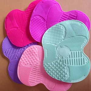 Detail of silicone makeup brush cleaning mats with multi-texture heart-shaped designs