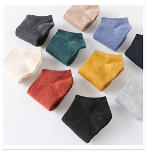 Flat lay of ten colorful knit cotton low cut socks arranged in a vibrant spectrum