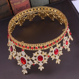 Detailed view of Baroque wedding crown with red gemstones and sparkling rhinestones