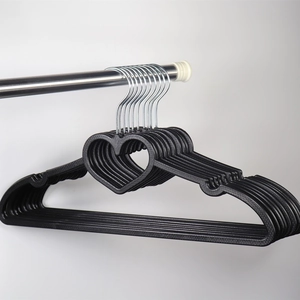 Detail of black heart-shaped plastic hangers with non-slip notches and metal hooks