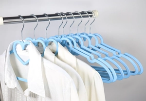 Detail of sky blue heart-shaped hangers with non-slip grips and swivel metal hooks