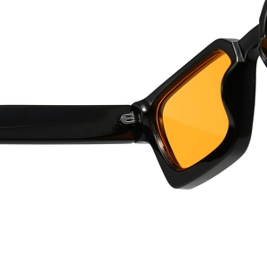 Detail of sturdy metal hinge on trendy thick black frame sunglasses with orange lenses