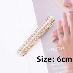 Detail of 6cm pearl and rhinestone hair clip with gold metal base and glossy finish