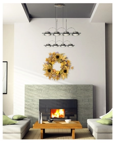 Detail of autumn wreath with green pumpkins and maple leaves on a fireplace wall