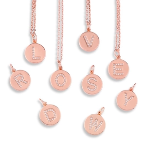 Detailed close-up of rose gold letter pendants with sparkling micro-pave zircon settings
