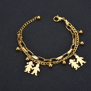 Detailed view of gold double-layer tree of life bracelet with boy and girl charms