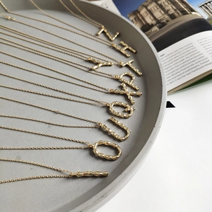 Golden 925 sterling silver alphabet necklaces with textured lava style pendants