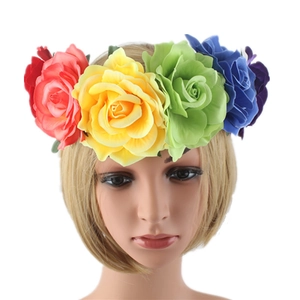 Close-up of rainbow artificial rose headband with red yellow green blue and purple flowers
