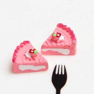 Detail of miniature pink strawberry resin cake slice for DIY crafts and dollhouse decor