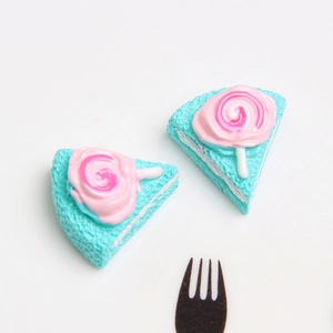 Detailed resin cake slice with pink lollipop topper in Tiffany blue and pink colors