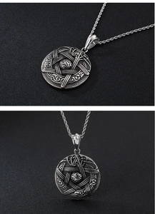 Macro detail of silver vintage pentagram and Celtic knot engraving on a round pendant