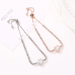 Detail showing two adjustable heart-shaped crystal bracelets in silver and rose gold finish
