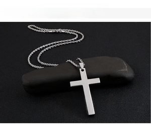 Close-up of minimalist stainless steel cross pendant on a classic rope chain necklace