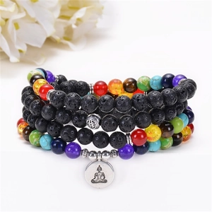 Detailed view of chakra beads and lava stone bracelet with a Buddha charm on white