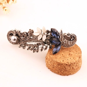 Vintage silver hair clip featuring peacock floral design with blue rhinestones and pearls