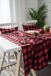 Detail of red and black buffalo plaid table runner with textured cotton linen fabric