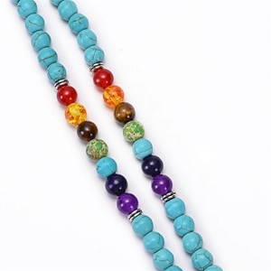 Detailed close-up of 7 chakra natural stones and turquoise beads with metal spacers