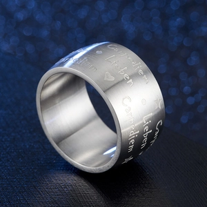 Macro shot of silver wide band ring featuring Carpe Diem and Lieben engravings with brushed finish