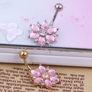 Detail of sunflower belly rings in silver and gold finish with pink and clear crystals