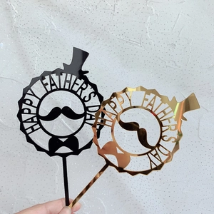 Close-up of black and gold mirror acrylic Happy Father's Day cake toppers with mustache