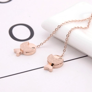 Minimalist rose gold titanium steel fish earrings featuring a matte and polished finish