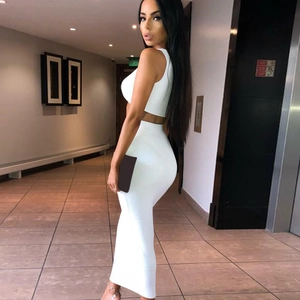 Detail view of a white two-piece set featuring a cropped top and high-waist maxi skirt