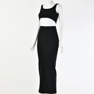 Detail of black knit ribbed two-piece set featuring a cropped vest and high-waist maxi skirt
