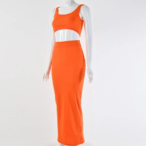 Detail of orange ribbed knit two-piece set featuring crop top and high-waist maxi skirt