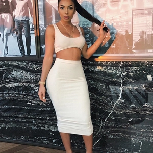 Detail view of white ribbed knit two-piece set featuring cropped tank top and midi skirt