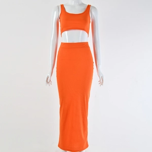 Detail of orange ribbed knit fabric on high waist maxi skirt and matching crop top set