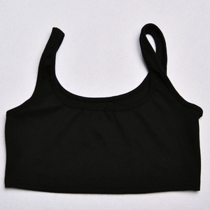 Close-up of black ribbed knit crop top featuring a minimalist U-neck sleeveless design