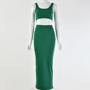 Detail of green ribbed knit two-piece set featuring cropped tank top and maxi skirt on model