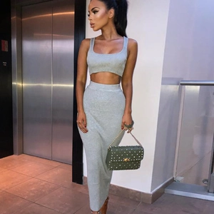 Detail of gray knitted two-piece set featuring a cropped tank top and long skirt for women