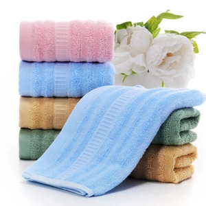 Detail of soft coral fleece towels with fruit embroidery in pastel colors and plush texture