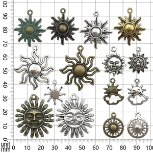 Mixed vintage sun pendants in silver and bronze finish on a grid scale for DIY jewelry