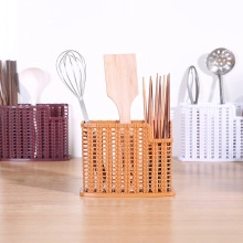 Close-up of brown plastic cutlery holder with woven texture storing kitchen utensils
