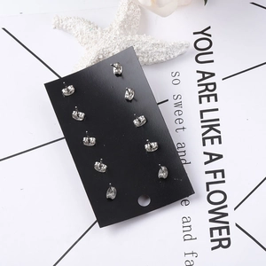 5-pair set of minimalist daisy and crystal cluster stud earrings on black card display