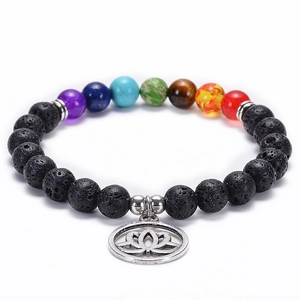 Close-up of chakra lava stone bracelet with seven colorful beads and lotus charm