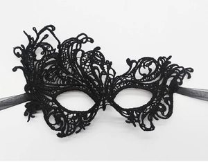 Detailed close-up of black polyester lace mask with intricate floral weaving patterns