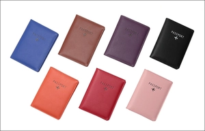 Flat lay of colorful RFID leather passport covers in blue, brown, black, and red