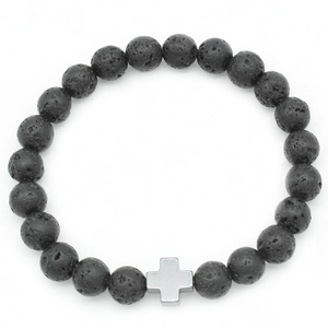 Macro detail of black volcanic lava stone beads with a silver metal cross on the bracelet