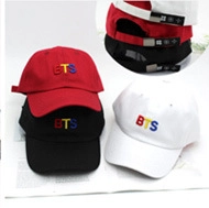 Detail of BTS embroidered letters on colorful cotton hats with adjustable back straps