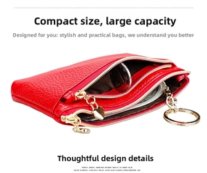 Detail of red litchi grain leather coin purse with double zippers and heart pendant